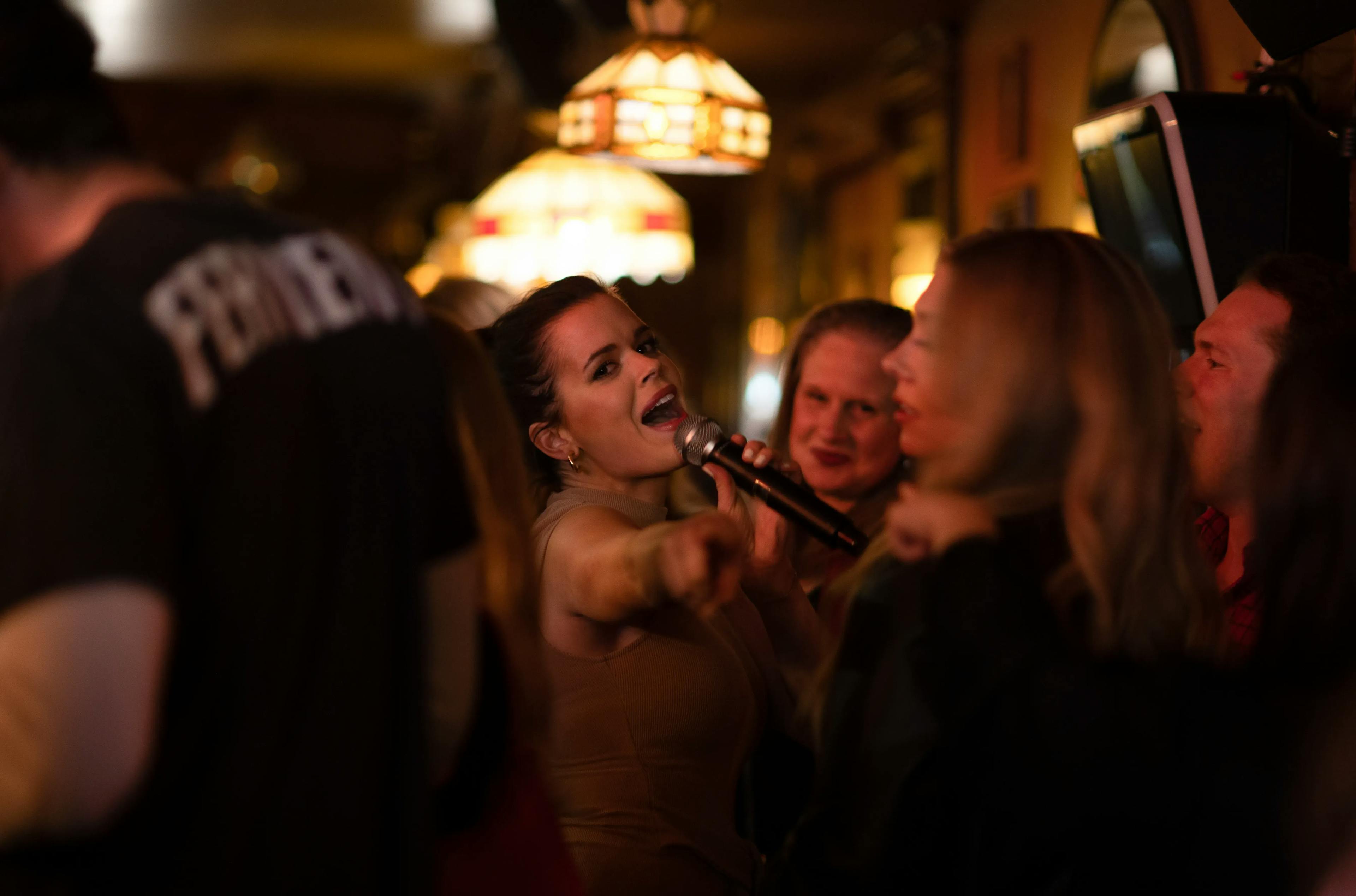 Woman singing karaoke at DC9 in Washington DC.